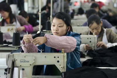 Women work in a garment factory in Hangzhou, east China’s Zhejiang province  Tuesday. Hundreds of factories in south China have shuttered because of  a collapsing global demand for exports. (Associated Press / The Spokesman-Review)