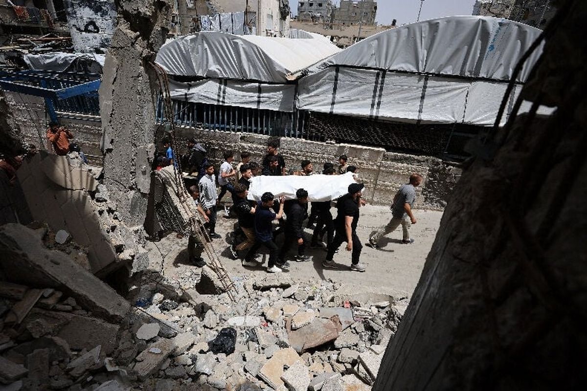 Mourners carry a body during the funeral of Palestinians who were killed in an Israeli strike, according to medics, on Sunday, in Gaza City.   (Reuters )