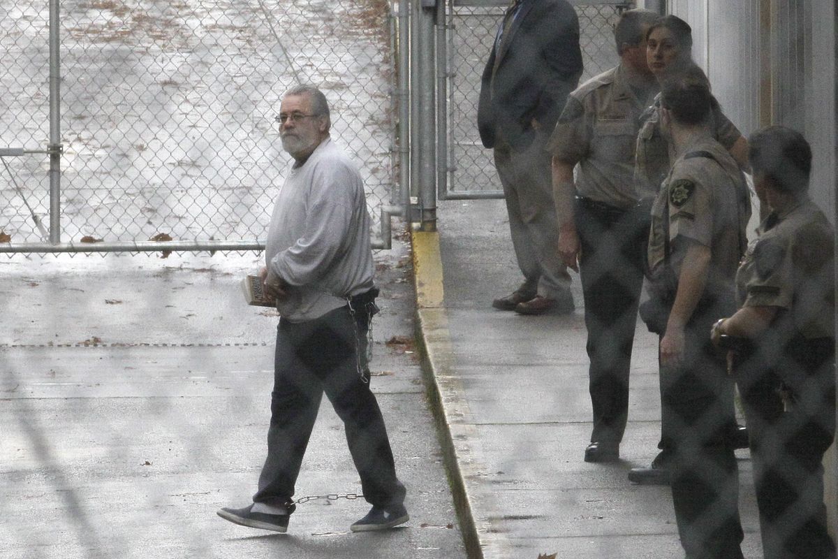 Bruce Turnidge walks out of the Marion County Courthouse following the guilty verdict on Wednesday in Salem. Turnidge and his son Joshua were convicted  of planting a bank bomb that killed two police officers in a botched robbery that prosecutors said was motivated by plans to build a militia.  (Associated Press)