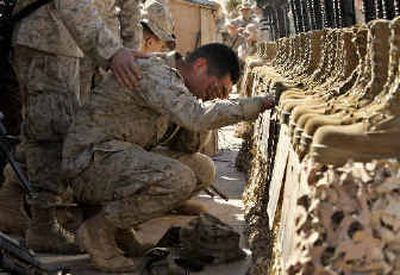 
A U.S. Marine  cries on Wednesday during the memorial service at Camp Korean Village, near Ar Rutbah, western Iraq, for 31 U.S. troops who were killed in a helicopter crash. 
 (Associated Press / The Spokesman-Review)