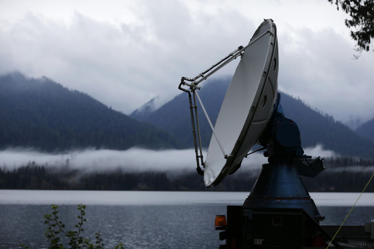 A truck-mounted radar instrument called the Doppler On Wheels scans cloudy skies Friday, Nov. 6, 2015, on the banks of Lake Quinault near Amanda Park, Wash. Led by NASA and hosted by the University of Washington, a team of meteorologists and scientists is fanning out across one of the wettest places in the country in November to measure raindrops and snowdrops and attempt to validate, on the ground, how well global satellites measure precipitation from space.
