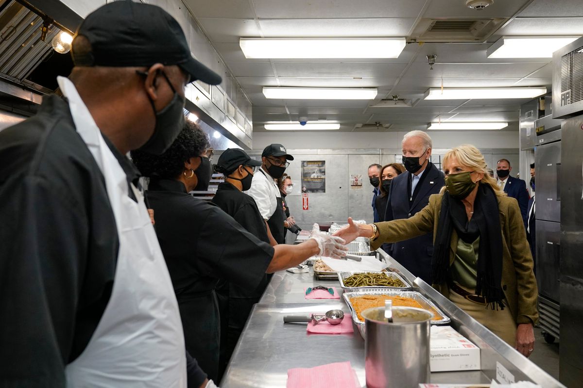 At right, President Joe Biden, first lady Jill Biden, Vice President Kamala Harris, and second gentleman Doug Emhoff, arrive to assemble Thanksgiving meal kits during a visit to DC Central Kitchen in Washington, D.C., Tuesday.  (Susan Walsh)