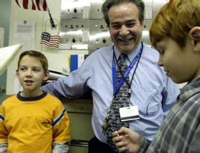 
For their birthdays, Austin Johnson, 8, left, and Jake Balcom, 11, receive pencils and cards from Principal Robert Bruce at Centennial Lane Elementary School in Ellicott City, Md., In lieu of edible treats.
 (Washington Post / The Spokesman-Review)