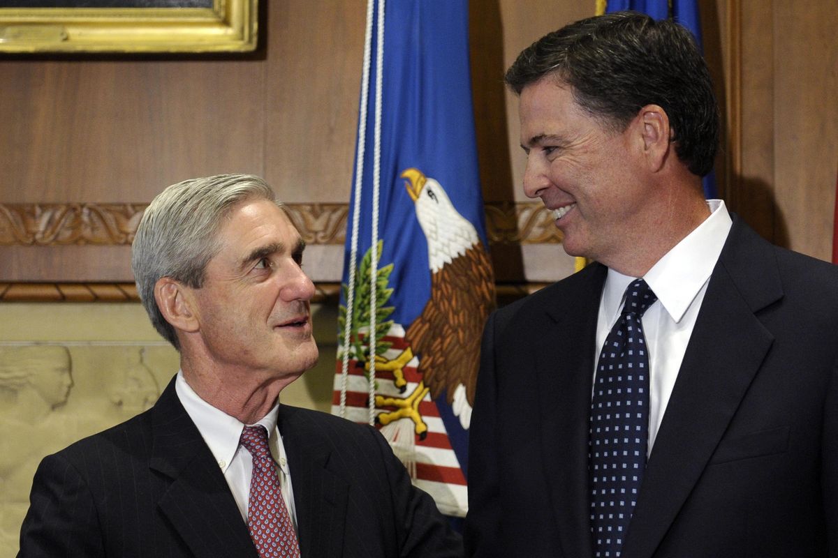 In this Sept. 4, 2013, file photo, then-incoming FBI Director James Comey talks with outgoing FBI Director Robert Mueller before Comey was officially sworn in at the Justice Department in Washington. On May 17, 2017, the Justice Department said it is appointing Mueller as special counsel to oversee investigation into Russian interference in the 2016 presidential election. (Susan Walsh / Associated Press)