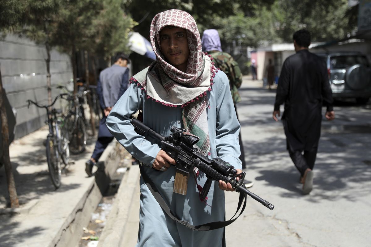 A Taliban fighter stands guard Sunday at a checkpoint in the Wazir Akbar Khan neighborhood in the city of Kabul, Afghanistan.  (Rahmat Gul)