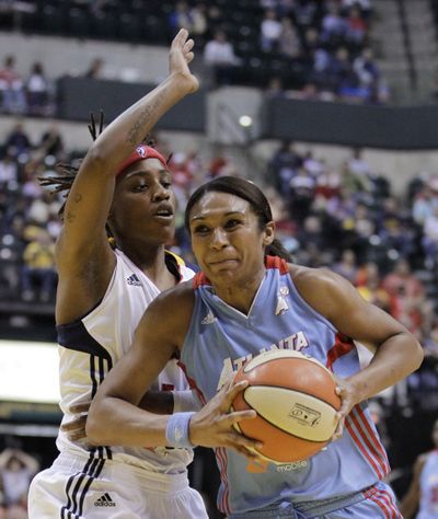 Atlanta’s Iziane Castro Marques drives against Indiana’s Shavonte Zellous during the first half of the Dream’s 83-67 victory. (Associated Press)