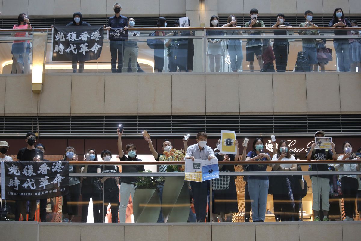 Pro-Hong Kong demonstrators shout slogans during a protest at a shopping mall in Hong Kong, Tuesday, June 16, 2020. Hong Kong leader Carrie Lam on Tuesday said she hoped that the opposition would not "demonize and stigmatize" the new national security law as doing do would mean pitting themselves against the people of Hong Kong.  (Kin Cheung)