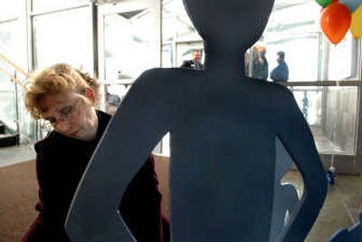 
Tinka Schaffer, of Children's Village Foundation,  assembles the Silent Witness display at Panhandle Health District in Hayden on Thursday during the  kickoff for Idaho's Child Abuse Prevention Month. 
 (Kathy Plonka / The Spokesman-Review)