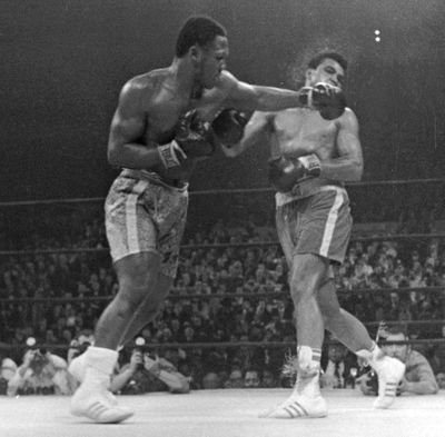 On March 8, 1971, Frazier delivers a left to Muhammad Ali in the 15th round of the first of their three fights. (Associated Press)