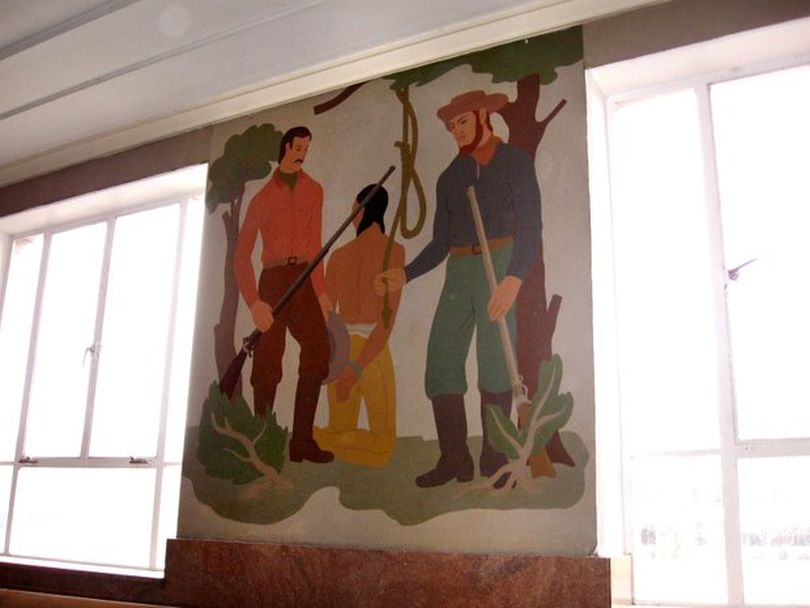 1930s-era mural in the former Ada County Courthouse, one of a series spread through the courthouse's central area, shows settlers hanging a Native American man. (State of Idaho)
