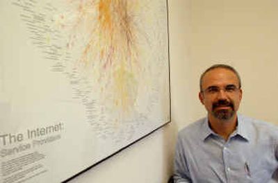 Rensselaer Polytechnic Institute computer science professor Bulent Yener poses in his office in Troy, N.Y., with a map created by Bell Labs of the major Internet Service Providers as they existed on Aug. 19, 1999.
(Associated Press / The Spokesman-Review)