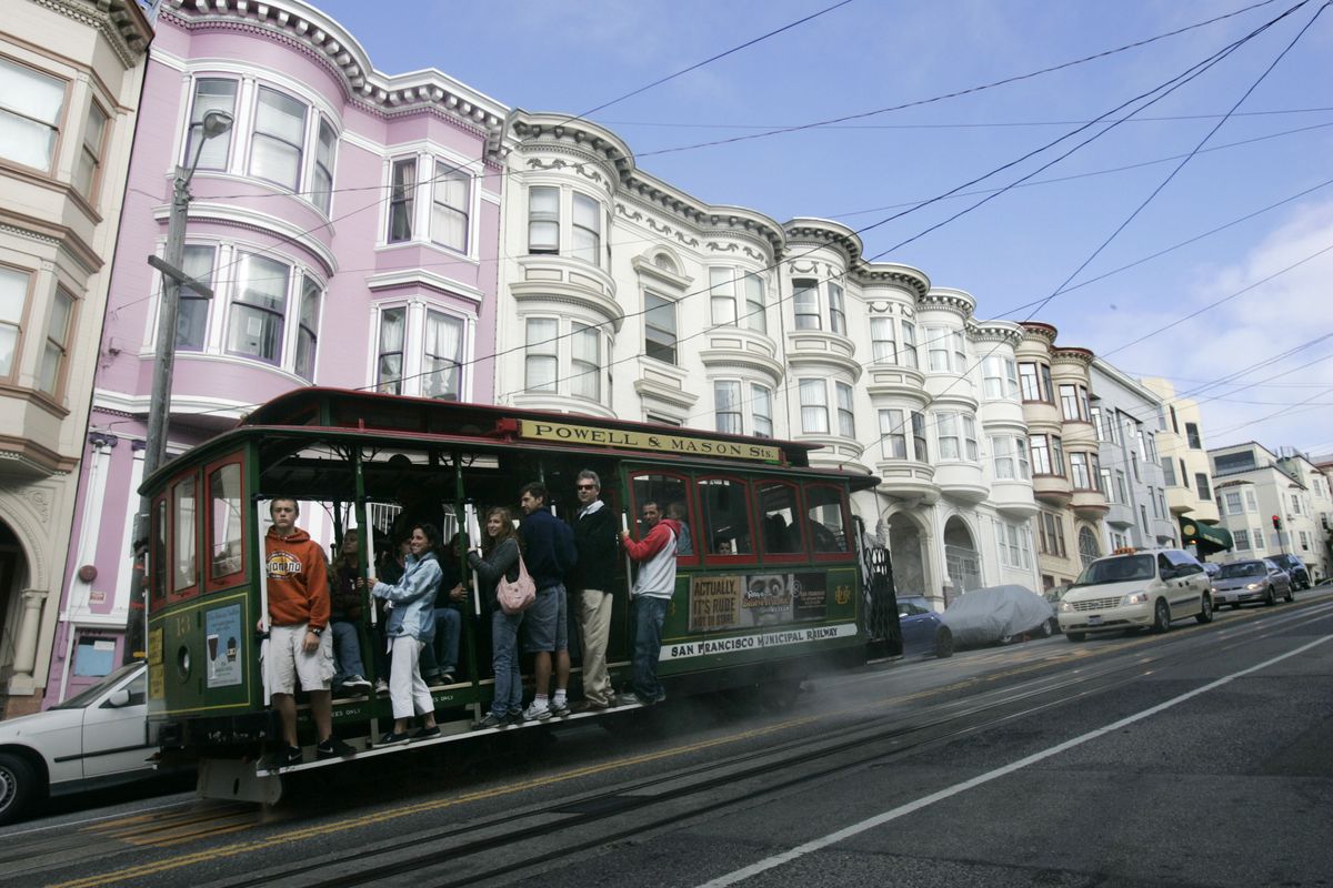 Associated Press Visitors ride the Powell-Mason cable car past the classic architecture of San Francisco homes along Mason Street. (Associated Press / The Spokesman-Review)