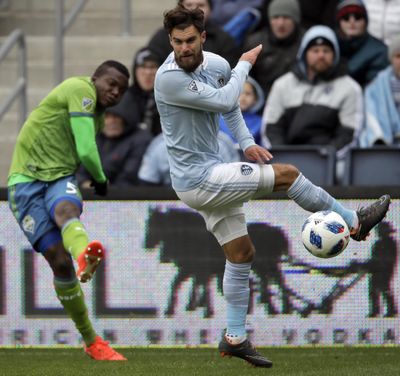 Sporting Kansas City midfielder Graham Zusi, right, blocks a kick by Seattle Sounders defender Nouhou Tolo during the first half. (Orlin Wagner / Associated Press)