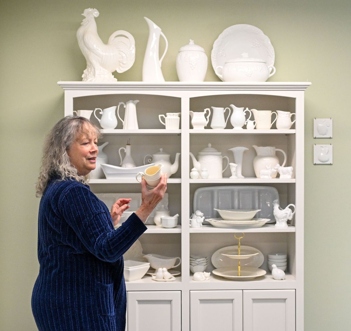 China dishes, porcelain vases and ceramic knickknacks fill a display cabinet in Cherylee Duncan’s kitchen and are scattered elsewhere in her South Hill home. She calls her collection “lumpy whites.” “Some are kind of lumpy, some have ridges or curves. I’m not a dish aficionado, but I know a lumpy white when I see it.”  (COLIN MULVANY/THE SPOKESMAN-REVIEW)