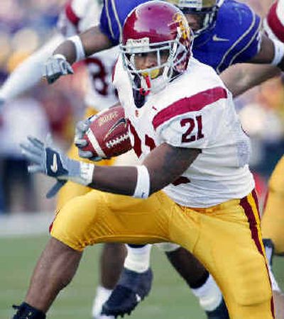 
USC's LenDale White looks for an opening during a TD run against Washington last year. 
 (Associated Press / The Spokesman-Review)