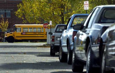 
Collins Road  is lined with cars during school hours  at University High School just across the street. Area residents want to extend the street's no-parking hours.
 (Holly Pickett / The Spokesman-Review)
