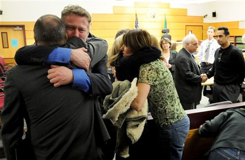 Jim Sanders' brother Derek Sanders and widow Charlene Sanders hug family and friends as the leave the courtroom after hearing the guilty verdicts read for Kiyoshi Higashi at Superior Court in Tacoma, Wash., Tuesday, March 8, 2011. Jurors deliberated for just a few hours before finding 23-year-old Higashi guilty as charged of first-degree murder, first-degree burglary and two counts each of second-degree assault and first-degree robbery. (Joe Barrentine /  (AP Photo/The News Tribune, Joe Barrentine))