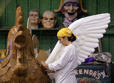 
Laura Franch applies papier-mache to a large rooster being constructed for the upcoming Mardi Gras season. Plans are under way for a shortened season that would include six days of parades rather than 11, culminating on Feb. 28.
 (Associated Press / The Spokesman-Review)