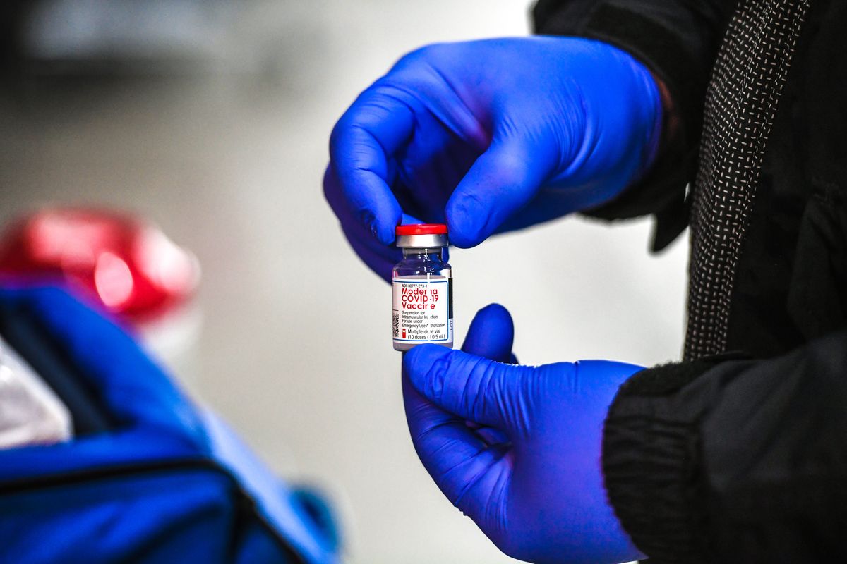 Paramedics administer the Moderna COVID-19 vaccine to local firefighters and first responders Jan. 4 at a drive-thru vaccination clinic put on by the Spokane Regional Health District. (DAN PELLE/THE SPOKESMAN-REVIEW)