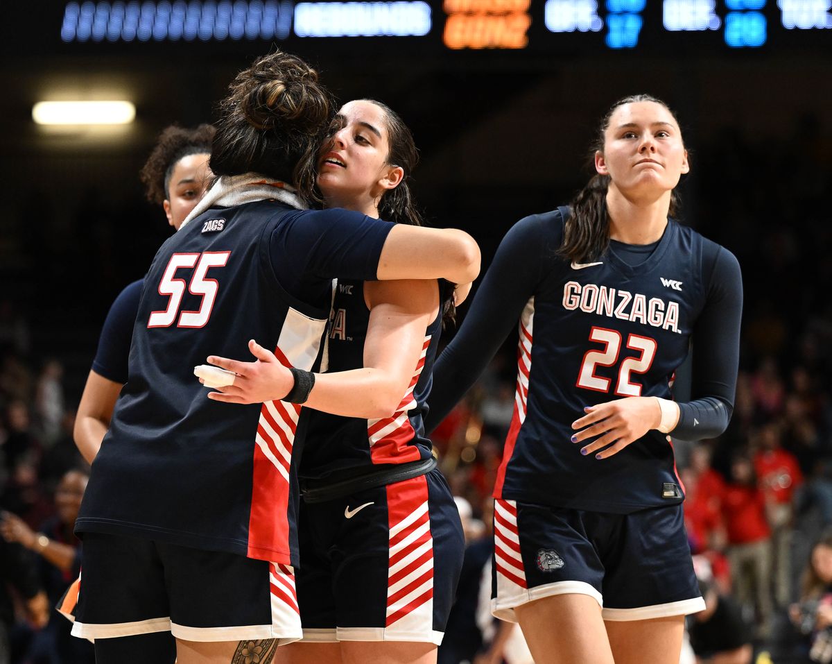 Gonzaga forward Zeryhia Aokuso, left, hugs guard Ines Bettencourt after losing to Ole Miss on Friday during the NCAA Tournament in Minneapolis.  (COLIN MULVANY/THE SPOKESMAN-REVI)