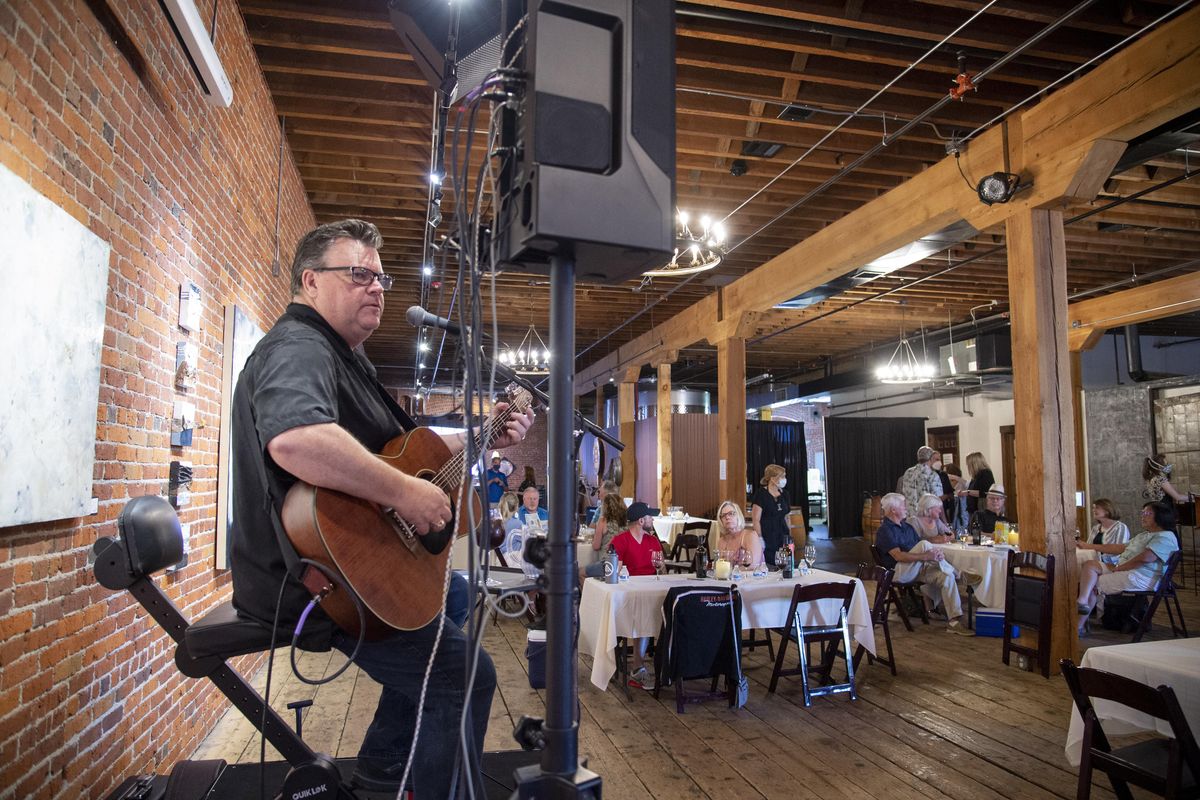 Longtime musician Sammy Eubanks belts out classic blues and pop songs from a small stage at the Barrister Winery in Spokane after the popular wine bar opened for a Wednesday night, June 3, 2020. “This is the first time I’ve performed outside of my house in two months,” Eubanks told the crowd. (Jesse Tinsley / The Spokesman-Review)