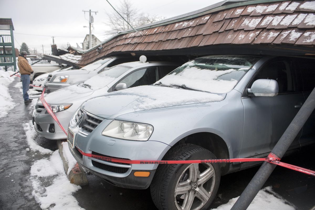 More than a dozen cars were damaged or destroyed Monday when a long carport collapsed Sunday at the Edgewater Village condominiums at 2121 E. Upriver Drive in Spokane. (Jesse Tinsley / The Spokesman-Review)