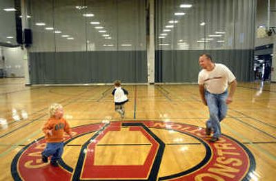 From left, 2-year-old Kaden Jones, his brother Tyler Jones, 5, and dad Brian Jones play their own version of Duck, Duck, Goose at the ValleyHUB open house Sunday.
(Holly Pickett / The Spokesman-Review)
