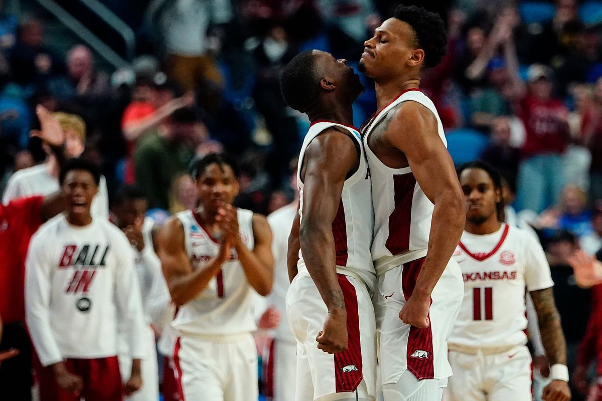 Arkansas’ Davonte Davis, left, celebrates with fellow guard Au’Diese Toney during the second half of the Razorbacks’ win over New Mexico State on Saturday. (Frank Franklin II)
