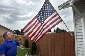 
 American Legion District 8 commander and veteran Lyle Carstens displays his American flag in his Spokane Valley yard Wednesday. He's a member of Citizens Flag Alliance, which is trying to get passed an amendment that would protect the flag.
 (Liz Kishimoto / The Spokesman-Review)