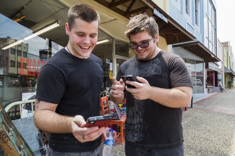 Brothers Jon and Ryan Edmonds play the augmented-reality smartphone game Pokémon Go in downtown Texarkana, Arkansas on Saturday. Released July 5, the game allows players to