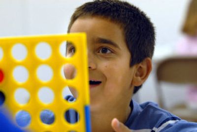 
Kahlil Tilbury, 7, can't believe he won a game of Connect 4 in the basement of the Post Falls Church of the Nazarene in Post Falls. 
 (Jesse Tinsley / The Spokesman-Review)