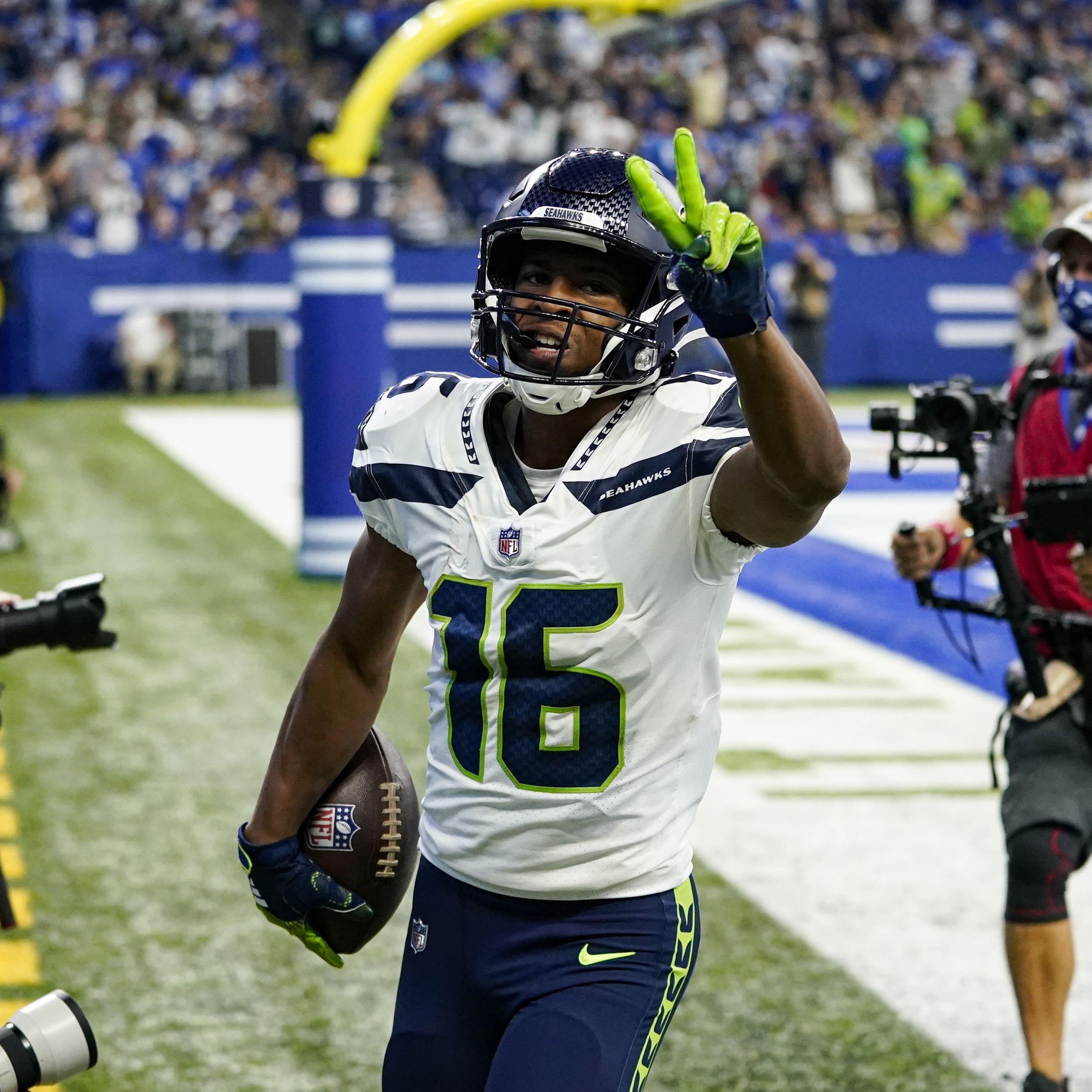 A Seattle Seahawks fan wearing a Russell Wilson jersey waves a