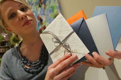 
Graphic designer Julie Weiss poses with samples of her custom-made envelopes at her home. E-mail may have revolutionized our communication, making it faster, easier, more practical, but the act of putting pen to paper seems to have gained in currency.  
 (Associated Press / The Spokesman-Review)