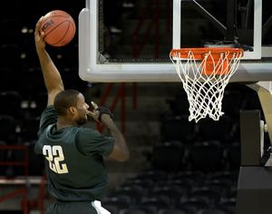 At the end of practice, Michigan State's Branden Dawson slam dunks the ball Wednesday afternoon. The Spartans play Delaware Thursday in a second round of the men's NCAA basketball tournament being held this week in the Spokane Arena. (The Spokesman-Review)