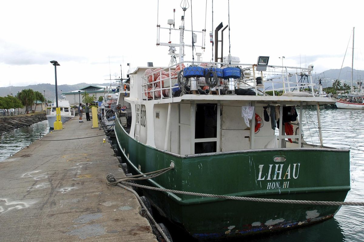 In this March 30, 2016 photo, the commercial longline fishing vessel Lihau is shown in Honolulu. The boat was sold and the name was changed to the Princess Hawaii, which sank off Hawaii's Big Island on Sunday, March 25, 2018. Eight people aboard the boat, including a federal fisheries observer, an American captain and six foreign fishermen, were rescued from their life raft about 12 hours after the vessel sank. (Caleb Jones / Associated Press)