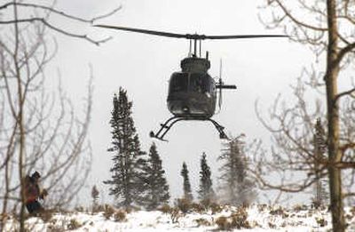 
An Army National Guard helicopter heads off to aid in the search for three missing snowmobilers Tuesday  north of Silverthorne, Colo. Associated Press
 (Associated Press / The Spokesman-Review)