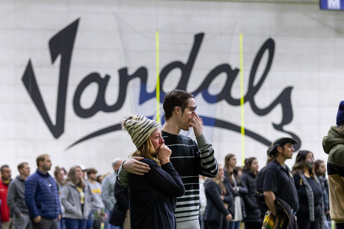 People wipe away tears Wednesday at the Kibbie Dome in Moscow, Idaho, during a vigil for the four University of Idaho students who were killed on Nov. 13.  (Geoff Crimmins/For The Spokesman-Review)