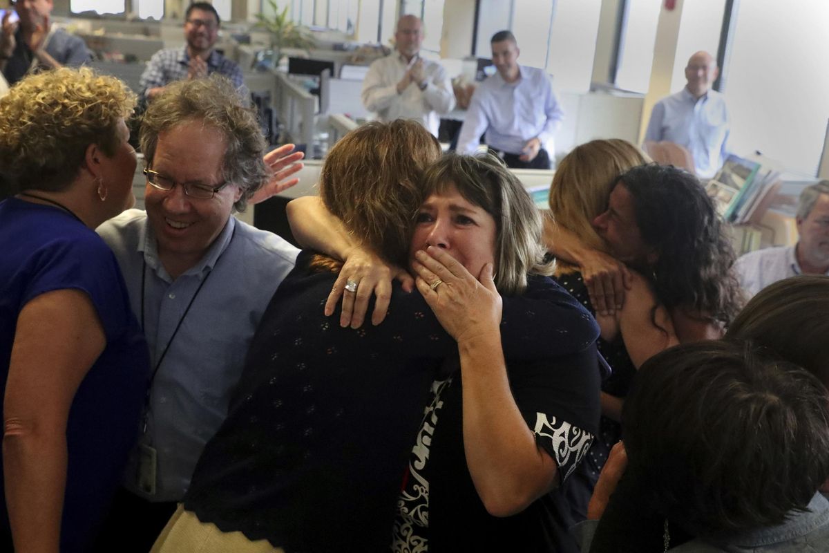Staff of the South Florida Sun Sentinel celebrate their bittersweet honor Monday, April 15, 2019, in Deerfield Beach, Fla., after winning the Pulitzer Prize for Public Service. The newspaper won for its coverage of the Parkland school shooting. (Carline Jean / AP)