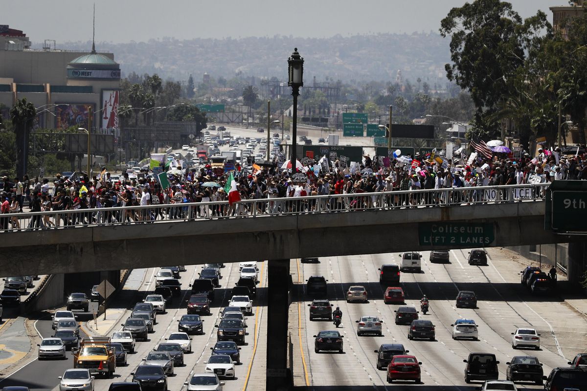 Thousands of protesters march over the 110 Freeway during a May Day rally Monday, May 1, 2017, in Los Angeles. (Jae C. Hong / Associated Press)