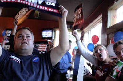 
Jeff Martin, left, with Hillary Hopewelly and Chase Perrin, both seniors at GU, watch at David's Pizza as President Bush announces his bid for re-election on Thursday evening. 
 (Kathryn Stevens / The Spokesman-Review)