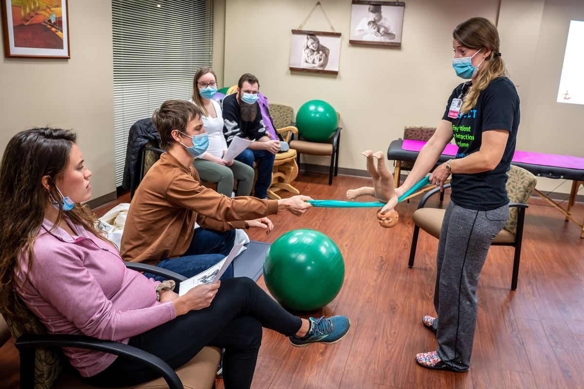 In the Spinning Babies parent class, nurse Laura Kaiser, on right, demonstrates how a baby passes through the pelvic muscles during childbirth with expecting couples Michelle and Henry Herman, at left, and Zoë Larzelier and Anthony Crook on Feb. 8.  (COLIN MULVANY/THE SPOKESMAN-REVIEW)