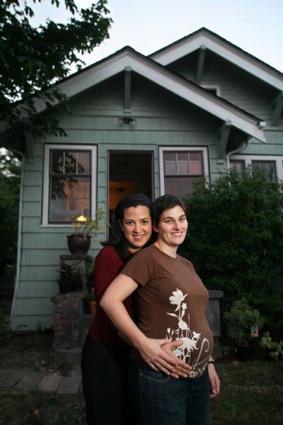 
Elizabeth Whitford, right, and Cristina Acevedo stand in front of their South Seattle home. Whitford is six months pregnant, and Acevendo plans to adopt the child after birth. 
 (Photos by JOHN FROSCHAUER Special to the Spokesman-Review / The Spokesman-Review)