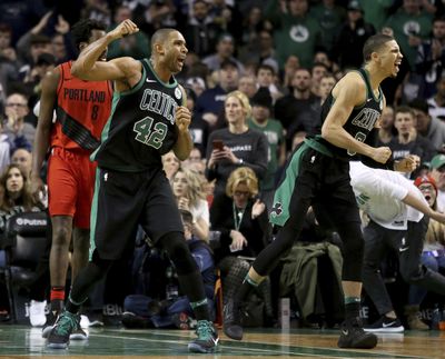 Celtics forwards Al Horford, left, and Jayson Tatum celebrate a call in their favor late in the second half of Sunday’s game against the Portland Trail Blazers in Boston. Horford hit the game-winning shot in the final seconds. (Mary Schwalm / AP)