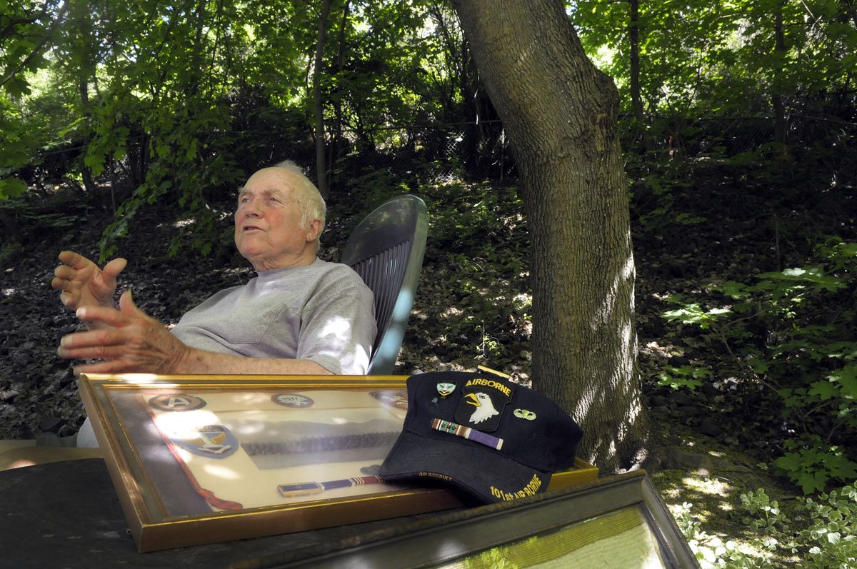 Ray Batten, of Spokane,  sits in the dappled shade of his backyard and reflects on his experiences during D-Day in World War II. (CHRISTOPHER ANDERSON / The Spokesman-Review)