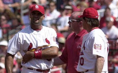 
Albert Pujols, left, holds his right side after pulling his right oblique muscle. 
 (Associated Press / The Spokesman-Review)