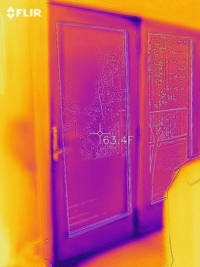 This is an infrared photo of an exterior door at my own home. You can clearly see small air leaks (darker blue spots) where cold air is leaking around the weatherstripping. (Tim Carter)