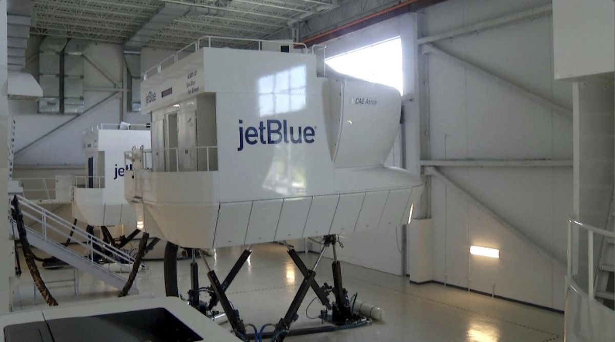 This Oct. 19, 2017, image made from a video shows a JetBlue flight simulator in Orlando, Fla. JetBlue Airways is beginning a small-scale program of training people with no flying experience, an approach used by Lufthansa and other international airlines. (Associated Press)