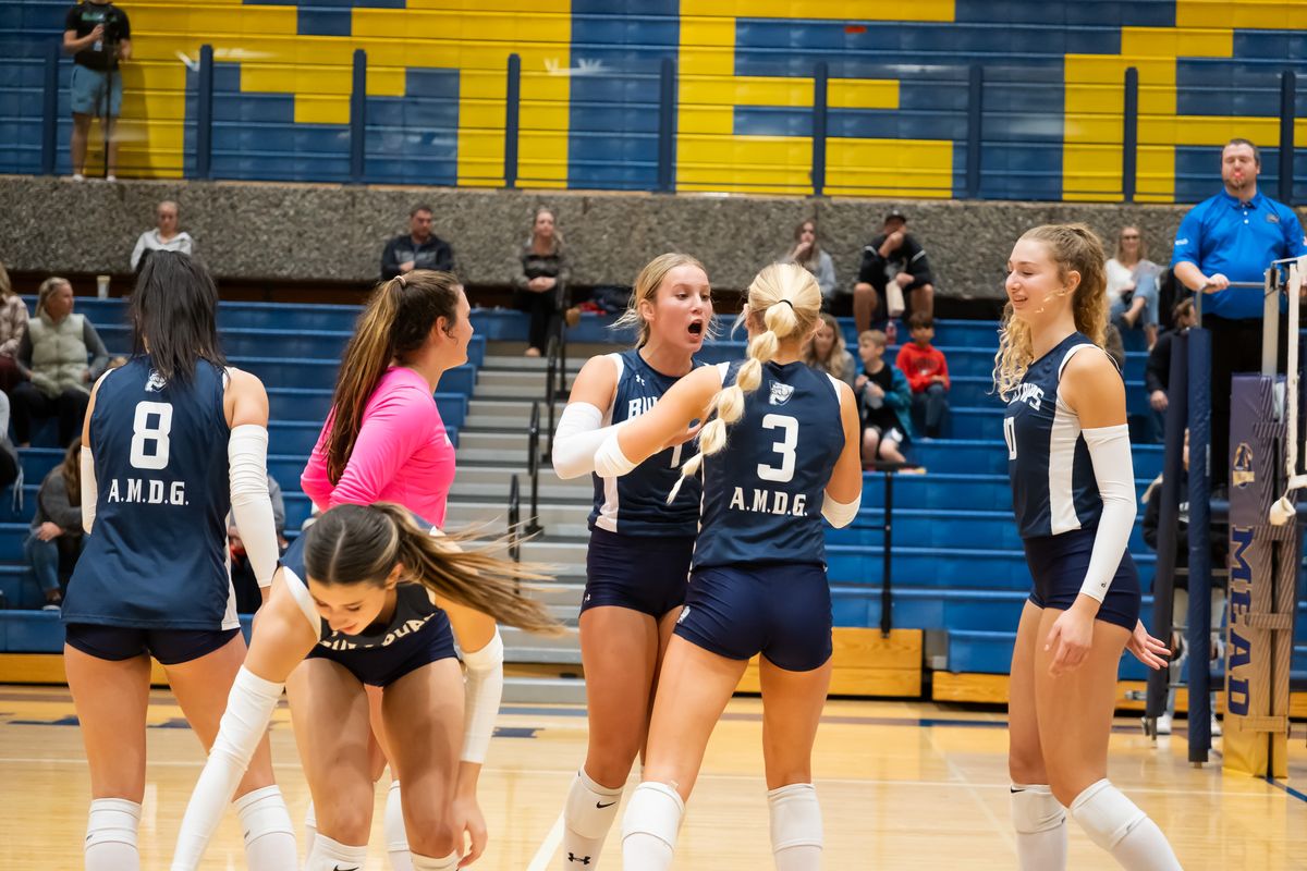 Gonzaga Prep players celebrate winning the first set against Mead during a GSL volleyball match Tuesday at Mead High School.  (Madison McCord/For The Spokesman-Review)