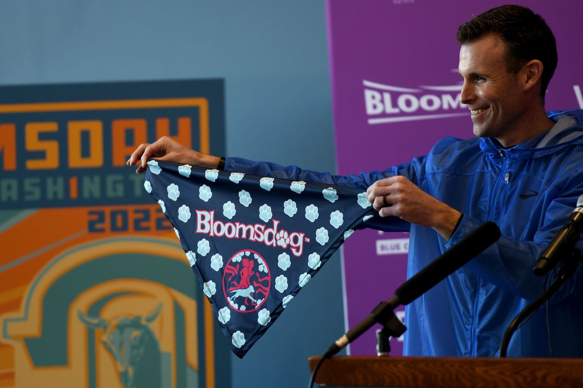 Bloomsday race director Jon Neill shows off the Bloomsdog bandana at a news conference at the Podium earlier this year. The bandana was available for the dogs of virtual runners.  (Kathy Plonka/The Spokesman-Review)