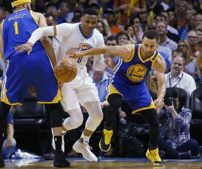 Oklahoma City Thunder guard Russell Westbrook (0) and Golden State Warriors guard Stephen Curry (30) reach for the ball during the third quarter of an NBA basketball game in Oklahoma City, Monday, March 20, 2017. Golden State won 111-95. (AP Photo/Sue Ogrocki) (Sue Ogrocki / AP)